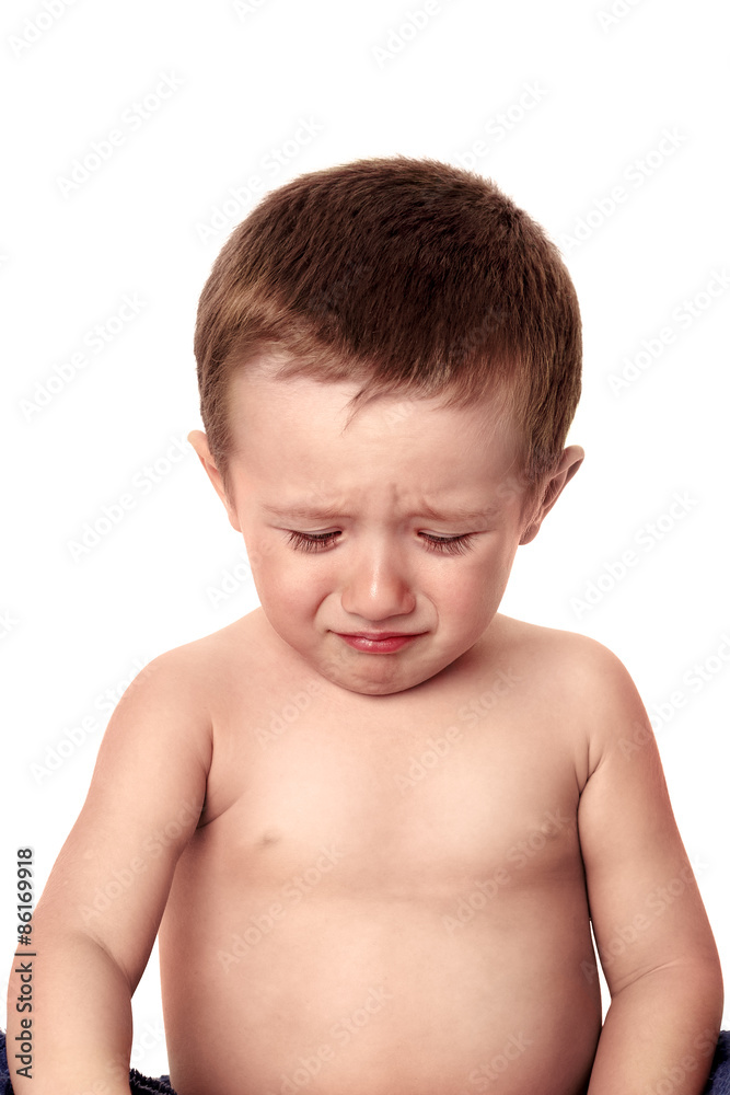Portrait of a crying baby, looking down with a tearful expressio Portrait of a crying baby, looking down with a tearful expressio