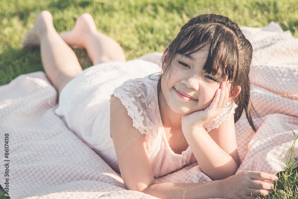 Beautiful asian girl lying on green gras Beautiful asian girl lying on green gras
