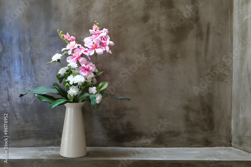 Bouquet of peonies in a vase against  wall. Interior
