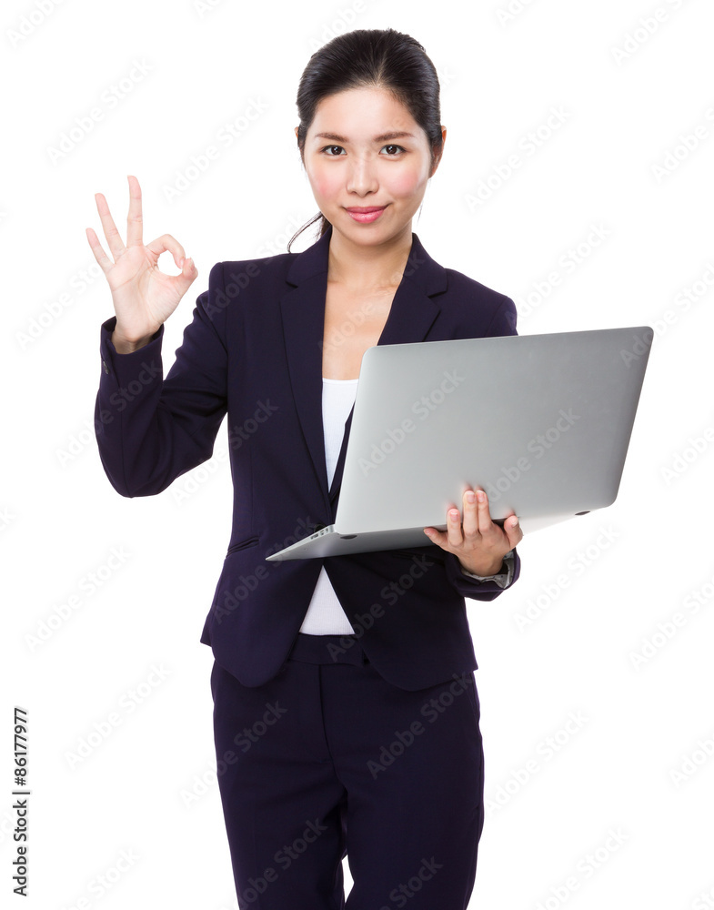 Asian businesswoman hold with laptop computer and ok sign gestur Asian businesswoman hold with laptop computer and ok sign gestur