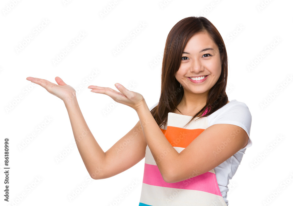 Young housewife with hand showing a blank side