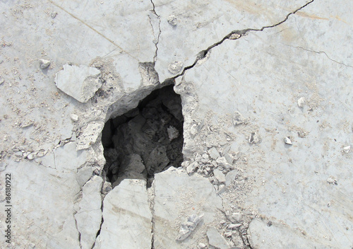 demolition hole in a large concrete white plate
