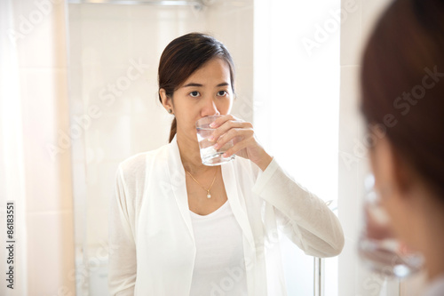 Asian young woman gargle on her mouth after tooth brushing photo