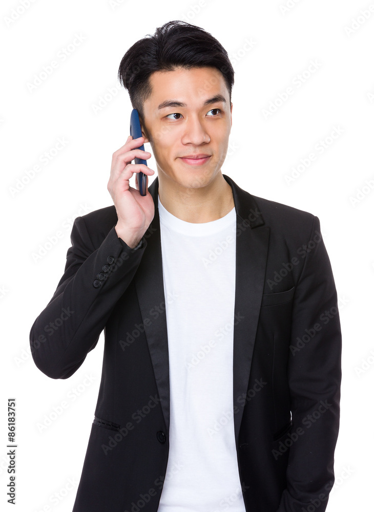 Businessman talk to cellphone and look away Businessman talk to cellphone and look away