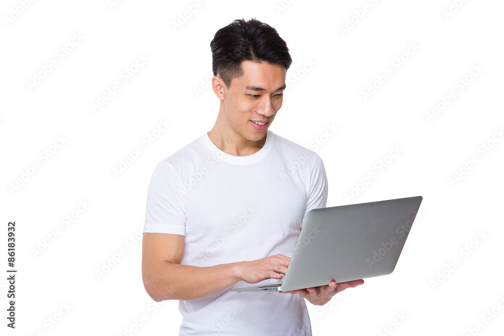 Asian man use of the laptop computer Asian man use of the laptop computer