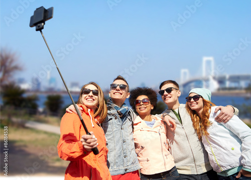 Photography smiling friends taking selfie with smartphone