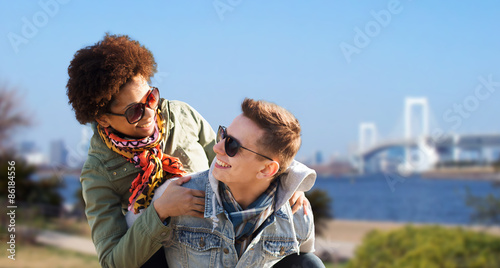 Canvas Print happy teenage couple in shades having fun outdoors