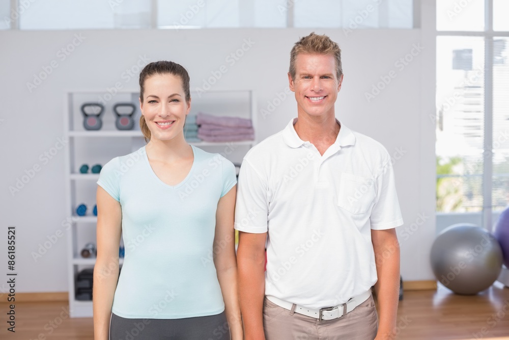 Smiling woman with her trainer looking at camera Smiling woman with her trainer looking at camera