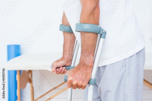 Patient standing with crutch 