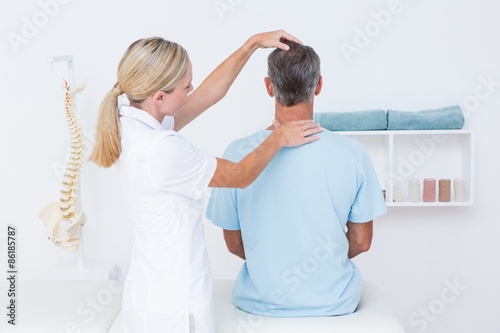 Doctor doing neck adjustment photo