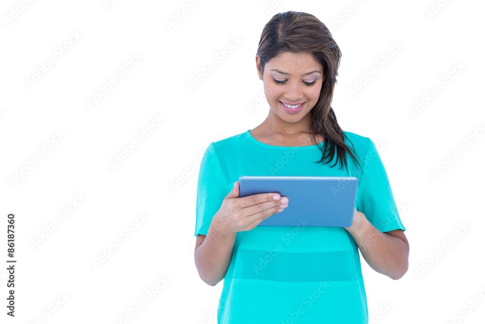 Happy pretty brunette using tablet computer Happy pretty brunette using tablet computer