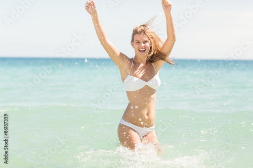 Happy pretty blonde cheering into the sea 