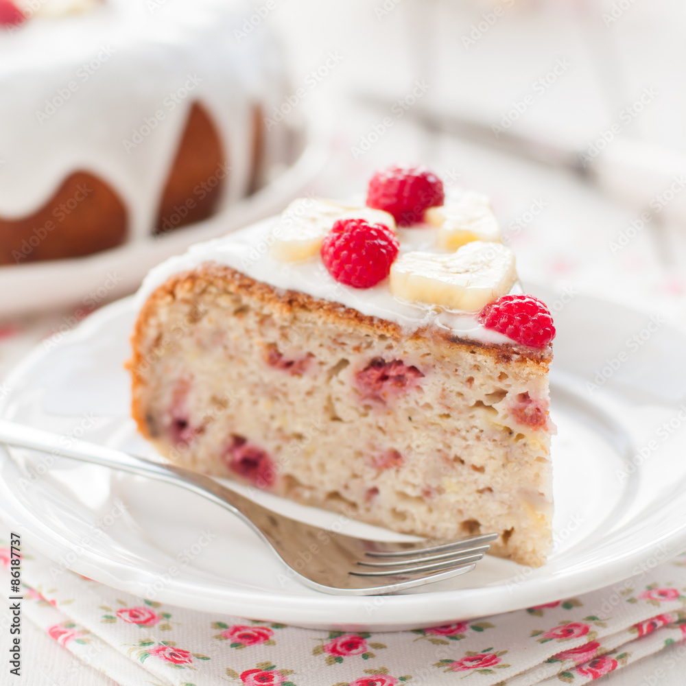 Banana Cake with Sugar Glaze Topped with Raspberries and Banana