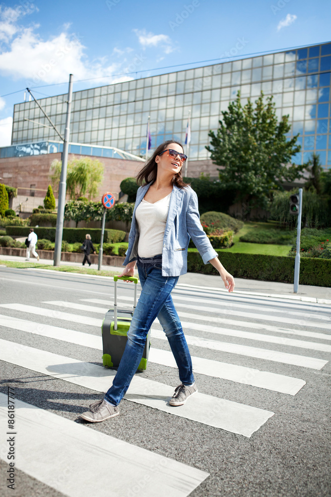 Young Woman at the Zebra Crossing with Luggage