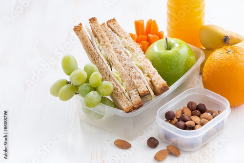school lunch with sandwich on white wooden table, close-up