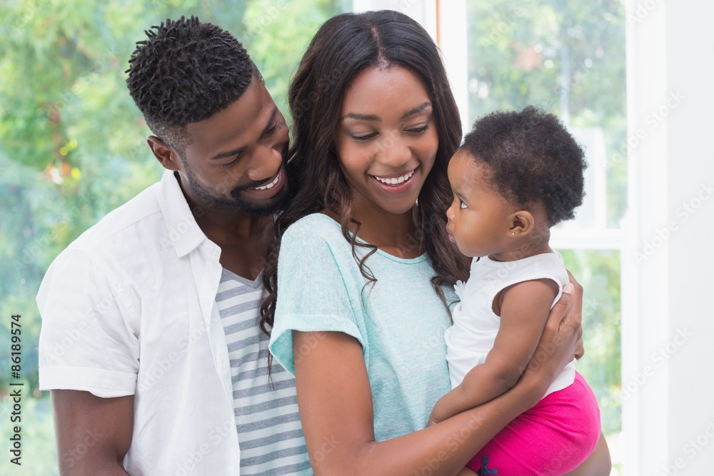 Obraz premium Happy parents with baby girl
