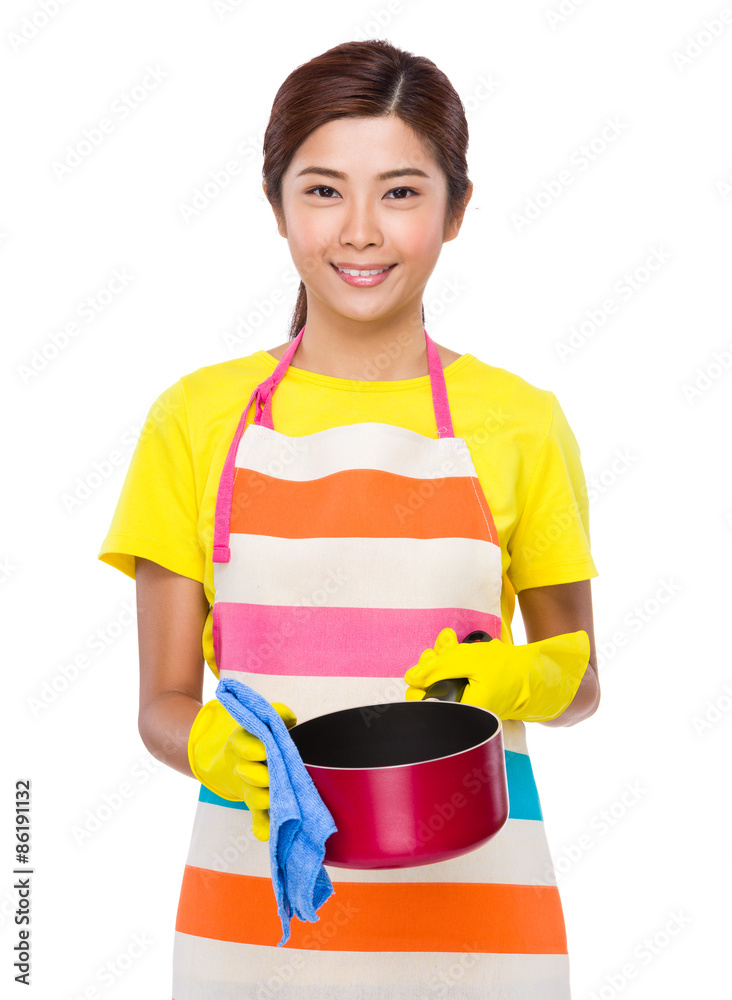 Asian Housewife washing the saucepan Asian Housewife washing the saucepan