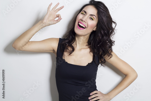 Young beautiful woman showing hand ok sign