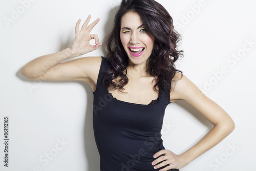 Young beautiful woman showing hand ok sign