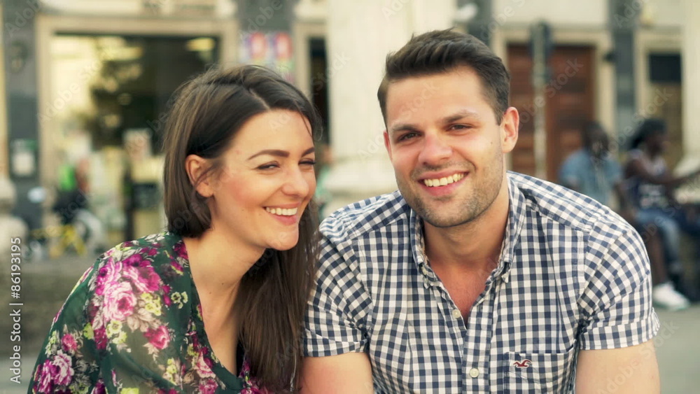 Couple chatting in the city and smiling to the camera
Couple chatting in the city and smiling to the camera