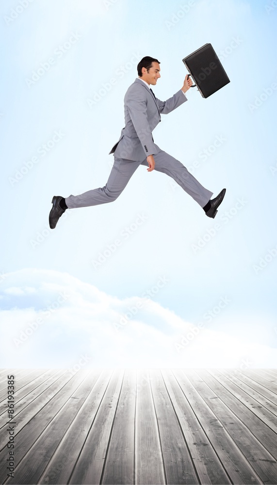Composite image of businessman running with a suitcase Composite image of businessman running with a suitcase