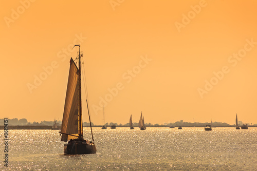 Frisian Dutch sailing ships during sundown photo