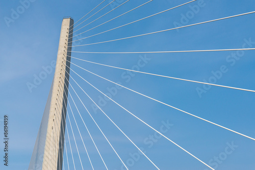 Fragment of a modern cable stayed bridge on the sky background. © Vladimir Arndt