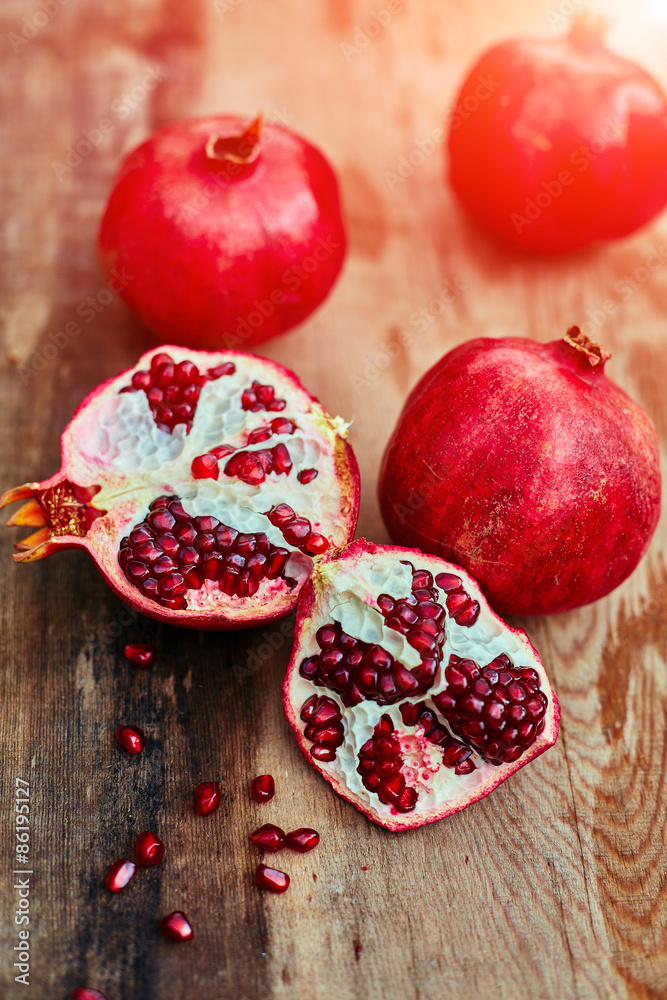 pomegranates on a dark wooden background pomegranates on a dark wooden background
