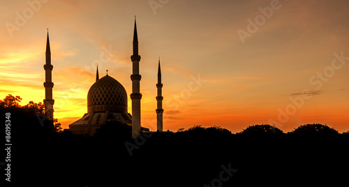 Silhouette of a mosque in sunrise.