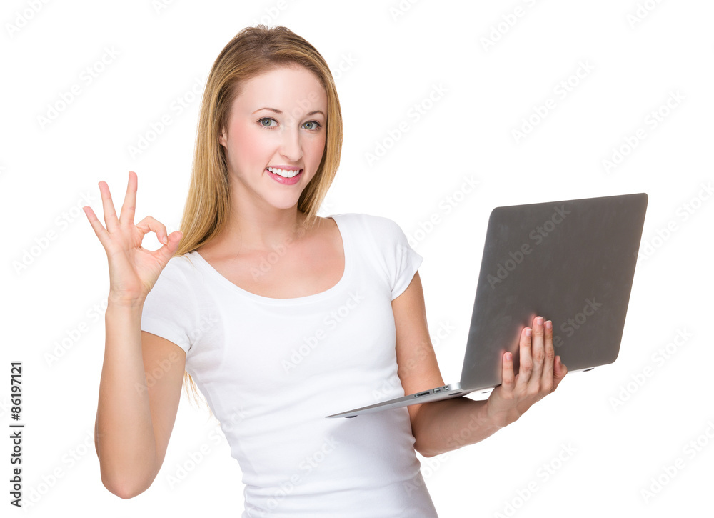 Caucasian woman hold with laptop computer and ok sign gesture Caucasian woman hold with laptop computer and ok sign gesture