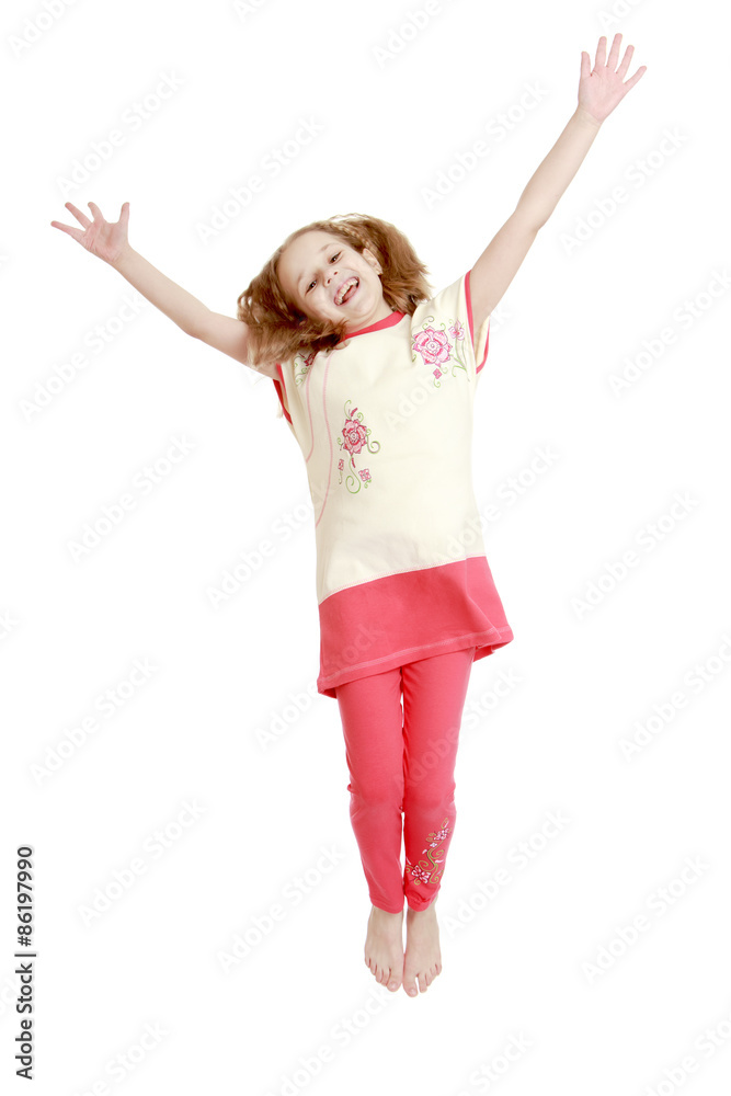 Joyful girl jumping with hands wide apart