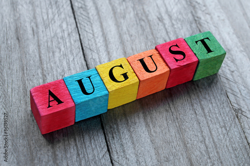 word august on colorful wooden cubes photo