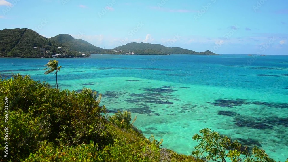 View of green lush Caribbean islands with beautiful turquoise and blue water View of green lush Caribbean islands with beautiful turquoise and blue water