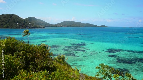 View of green lush Caribbean islands with beautiful turquoise and blue water photo