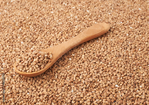 Wooden spoon over the buckwheat