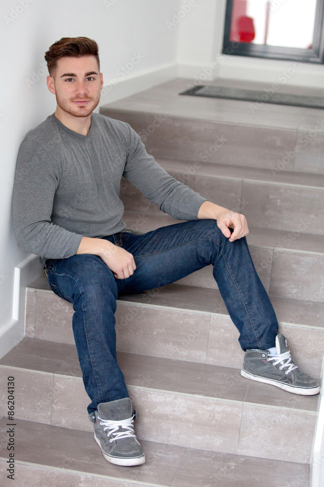 Casual cool man sitting on the stairs Casual cool man sitting on the stairs