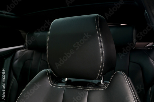 Modern car leather headrest. Interior detail.