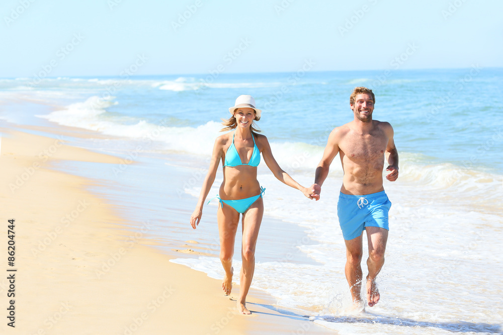 Couple having fun running on the beach Couple having fun running on the beach