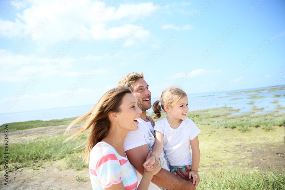 Portrait of happy family walking together in natural landscape