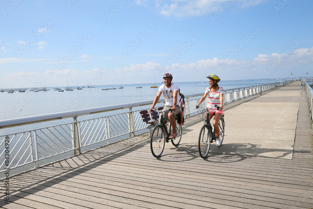 Fototapeta premium Family on a biking journey by the sea