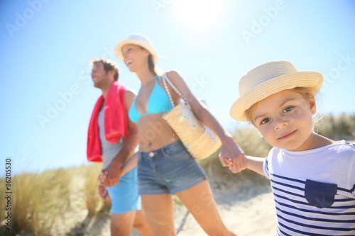 Family walking to the beach on a sunny day