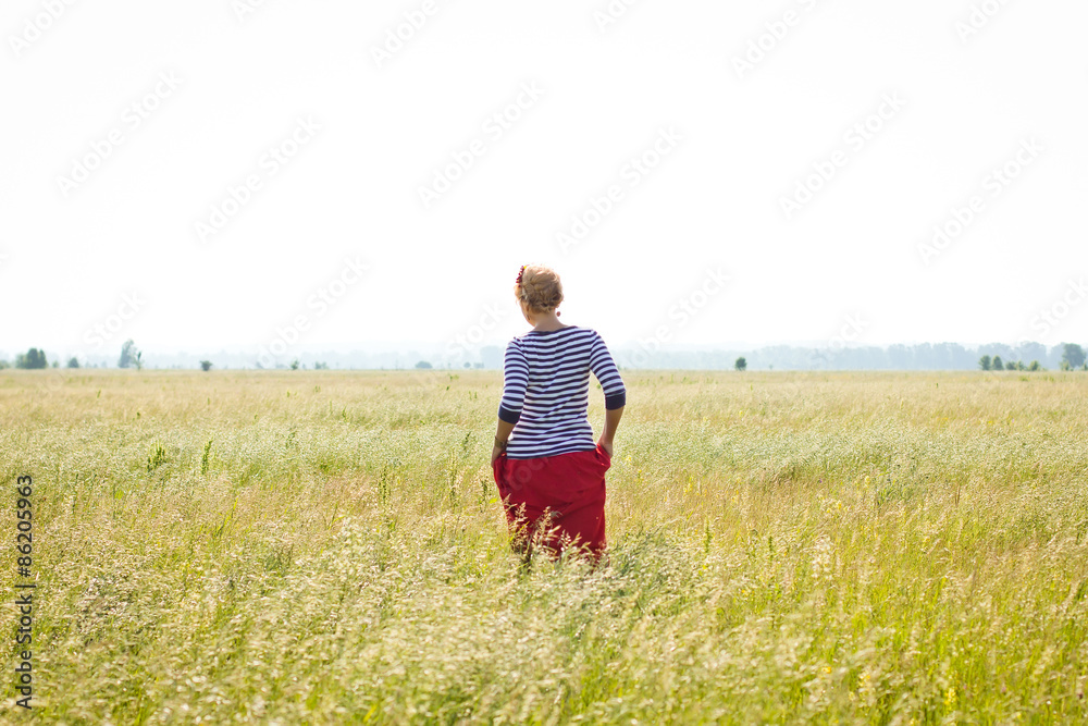 Young woman on summer field portrait