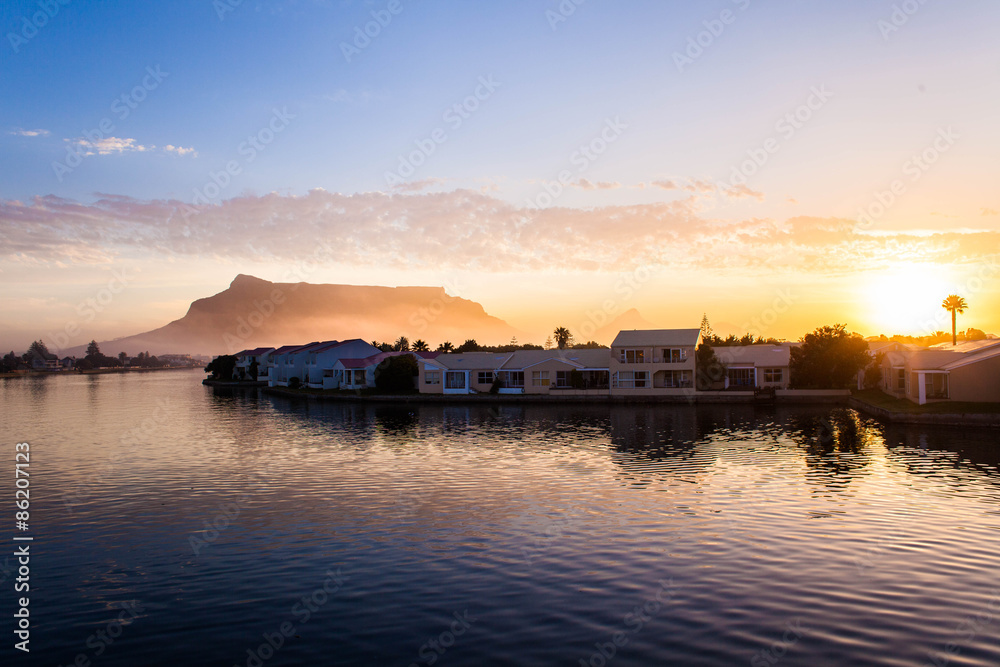 Houses along River at sunset with Table Mountain