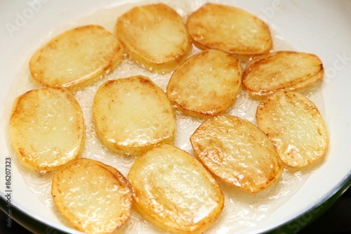 Frying potatoes.