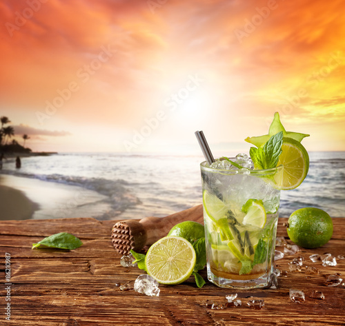 Mojito drink on beach with sunset