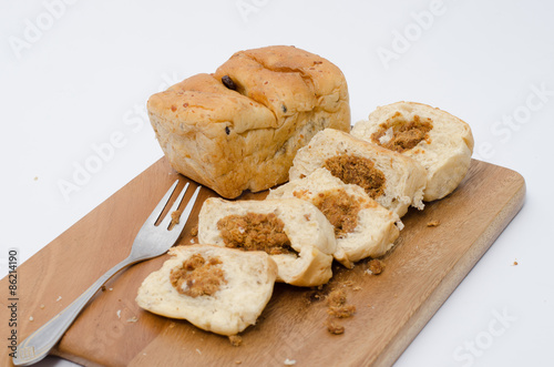 dried shredded pork bread on cutting board on a white background
