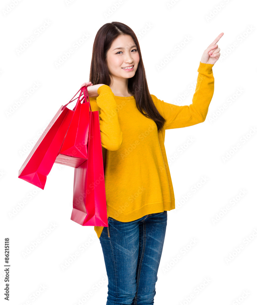Young woman with shopping bag and finger point up Young woman with shopping bag and finger point up