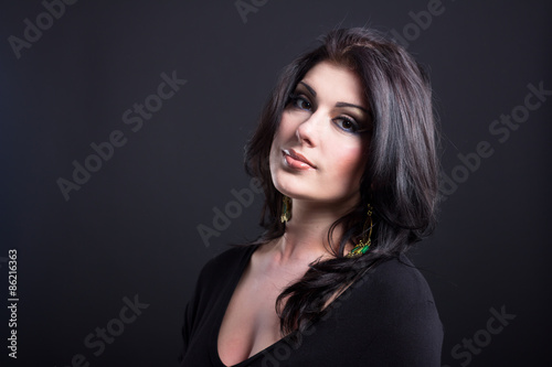 Portrait of a beautiful young brunette. Beautiful woman with shiny hair. Impressive woman