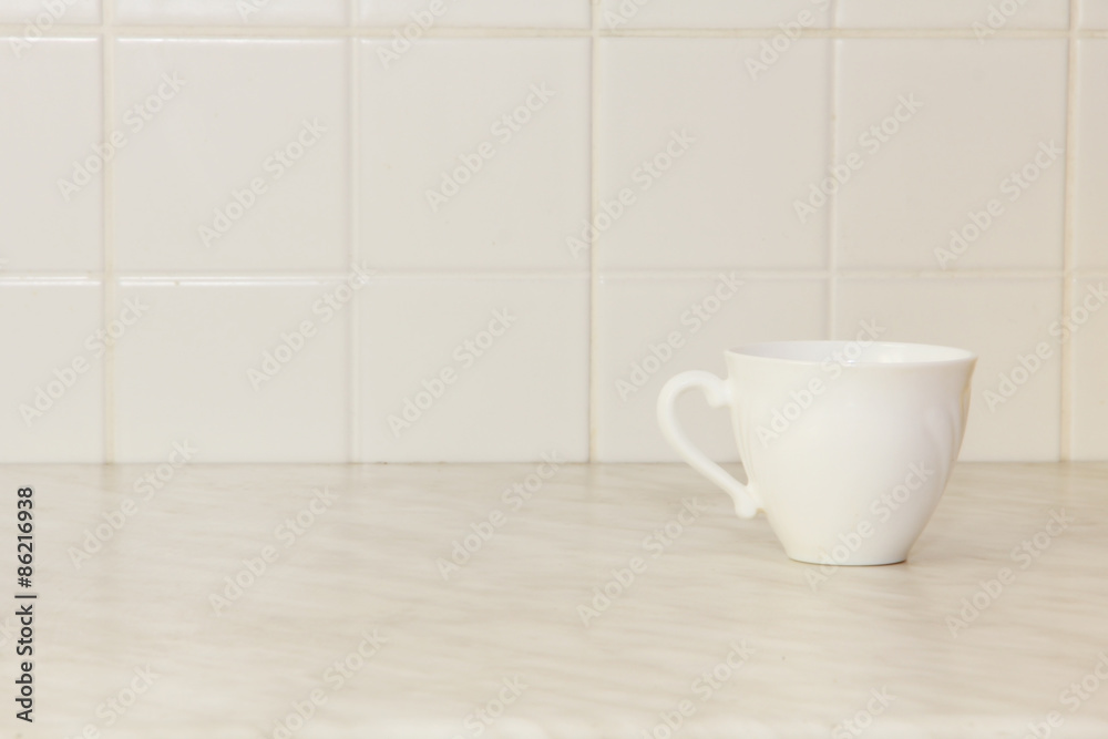 Ceramic tea cup on white kitchen table. Ceramic tea cup on white kitchen table.