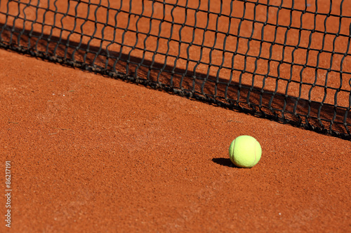 tennis ball on the court © AlexZlat